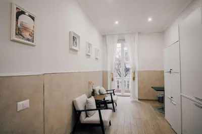 a living room with two chairs and a table at Casa Mirabilia in Rome