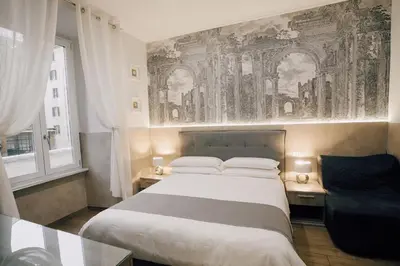 a bedroom with a large bed and a window at Casa Mirabilia in Rome