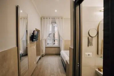 a small room with a bed and a window at Casa Mirabilia in Rome