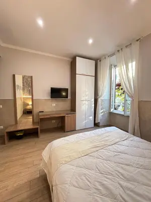 a bedroom with a large bed and a television at Casa Mirabilia in Rome