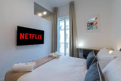 a bedroom with a bed with a netflix sign on the wall at [15 minutes from the centre] Free Wi-Fi & A/C in Rome