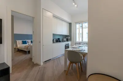 a kitchen and living room with a table and chairs at [15 minutes from the centre] Free Wi-Fi & A/C in Rome