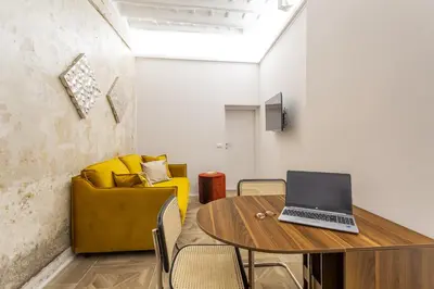 a room with a table with a laptop on it at Daplace - Elena Apartment in Rome