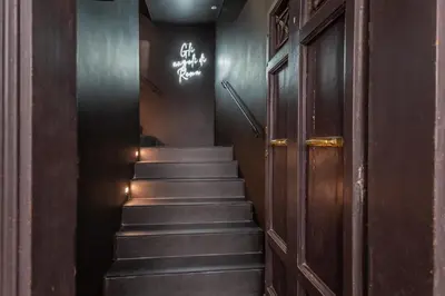 a staircase in a building with a door and a sign at Daplace - Elena Apartment in Rome