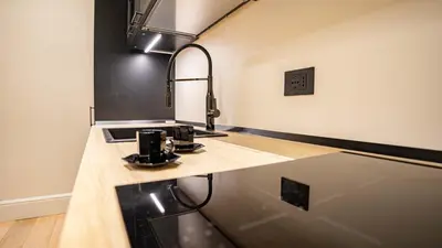 a kitchen counter with a sink and a mirror at Pinciana - Veneto - Marilyn House in Rome