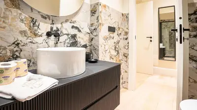 a bathroom with a sink and a mirror at Pinciana - Veneto - Marilyn House in Rome