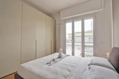 a bedroom with a large white bed with a window at Design Monteverde Flat in Rome