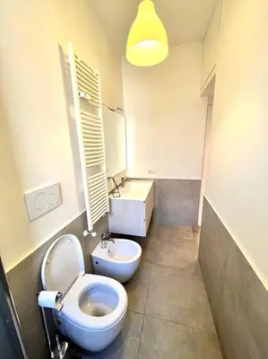 a bathroom with a white toilet and a sink at The Fontana Carlotta at Garbatella in Rome