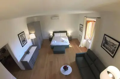a small room with a bed and a couch at Nesty Margana House in Rome