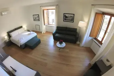 a living room with a bed and a couch at Nesty Margana House in Rome
