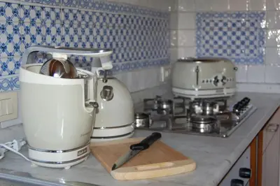 a kitchen counter with a white appliance on a counter top at Nesty Margana House in Rome