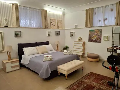 a bedroom with a large bed and a chair at la Borghese in Rome