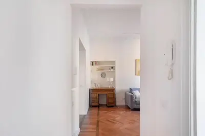 a living room with a table and a couch at Appartamento “La Palma nel Cortile” in Rome