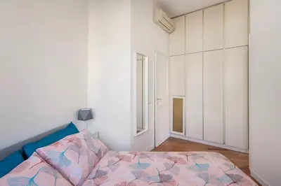 a bedroom with a bed and a picture on the wall at Appartamento “La Palma nel Cortile” in Rome