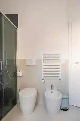 a bathroom with a glass shower and a toilet at Appartamento “La Palma nel Cortile” in Rome
