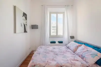 a bed in a bedroom with a window at Appartamento “La Palma nel Cortile” in Rome