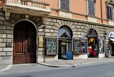 a store on the side of a street with a building at Sofia's Suites Guesthouse in Rome