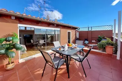 a patio with a table and chairs on a balcony at Terrace Mariù Apartment in Rome