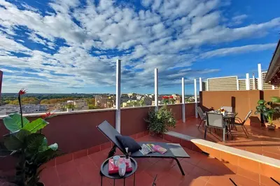 a balcony with a table and chairs on a roof at Terrace Mariù Apartment in Rome