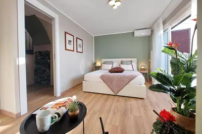 a bedroom with a bed and a table in it at Terrace Mariù Apartment in Rome