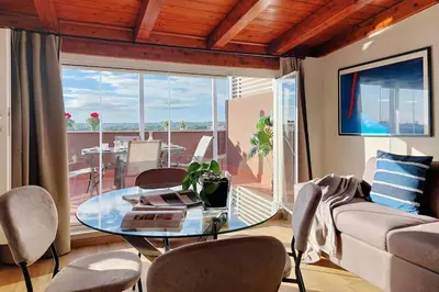 a living room with a glass table and a couch at Terrace Mariù Apartment in Rome