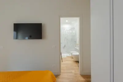 a bedroom with a bed and a television on a wall at Cattaneo monti delizioso e nuovissimo appartamento in Rome