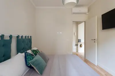 a bedroom with a bed with a blue headboard at Cattaneo monti delizioso e nuovissimo appartamento in Rome