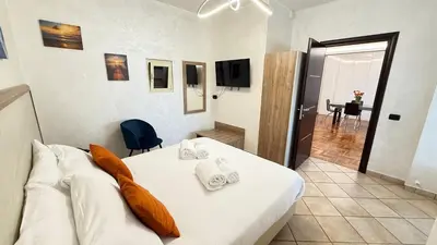 a bedroom with a white bed with orange pillows at LUXURY AV in Rome