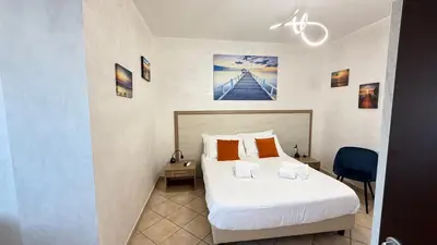 a bedroom with a large white bed with orange pillows at LUXURY AV in Rome
