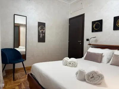 a bedroom with a bed with towels on it at LUXURY AV in Rome