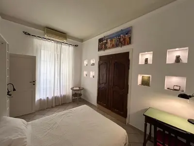 a bedroom with a bed and a wooden door at Vacanze Romane in Rome