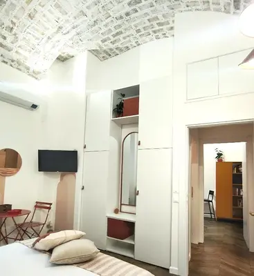 a bedroom with white walls and a coffered ceiling at Vera Roma Suite&Apartment - Charming 3 bedroom apt - 20min walk from Colosseum in Rome