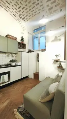a living room with a bed and a kitchen at Vera Roma Suite&Apartment - Charming 3 bedroom apt - 20min walk from Colosseum in Rome