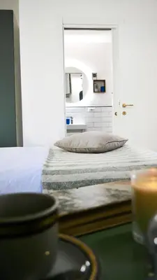 a bedroom with a bed and a mirror at Vera Roma Suite&Apartment - Charming 3 bedroom apt - 20min walk from Colosseum in Rome