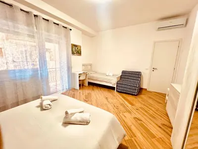 a white room with a bed and a couch at 15 Min. Colosseo 1 - Casa di Giò in Rome