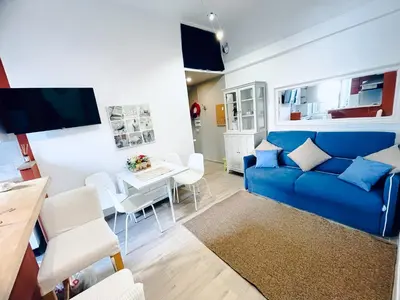 a living room with a blue couch and a table at San Lorenzo 47 Loft in Rome