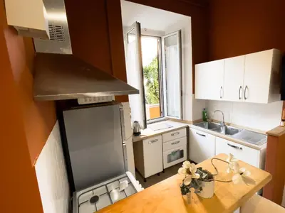 a small kitchen with a table and a stove top oven at San Lorenzo 47 Loft in Rome