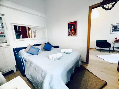 a bedroom with a bed with blue pillows on it at San Lorenzo 47 Loft in Rome