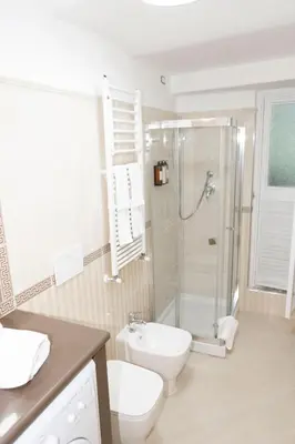 a bathroom with a shower and a toilet and a sink at Domus Vitra 23 in Rome