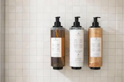 a group of three bottles ofodorizers on a wall at Domus Vitra 23 in Rome