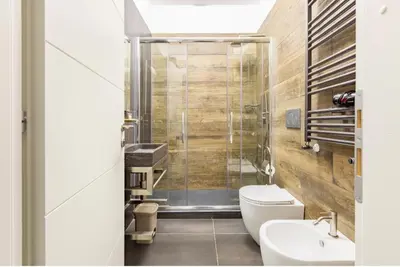 a bathroom with a shower and a toilet and a sink at Azzurra Guest House Vaticano in Rome