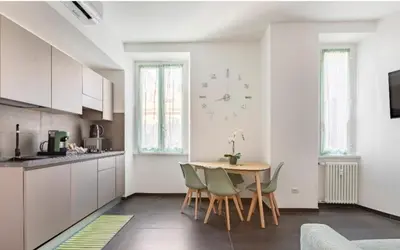 a kitchen and dining room with a table and chairs at Azzurra Guest House Vaticano in Rome
