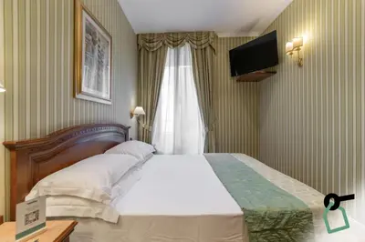 a bedroom with a large bed and a window at HOTIDAY Room Collection - Roma Porta Pia in Rome