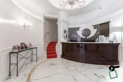 a lobby with a staircase and a mirror on the wall at HOTIDAY Room Collection - Roma Porta Pia in Rome