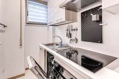 a kitchen with a sink and a dishwasher at Residenza Coppedè in Rome