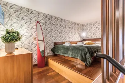 a bedroom with a bed and a surfboard on a wall at Residenza Coppedè in Rome