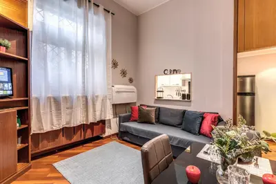a living room with a couch and a table at Residenza Coppedè in Rome