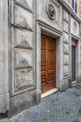 a large wooden door on the side of a building at Colosseum Oasis in Rome