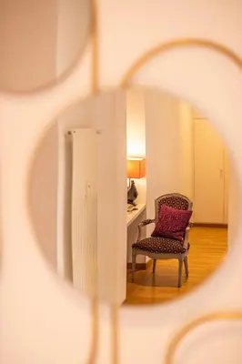 a chair with a purple pillow in a room at Colosseum Oasis in Rome