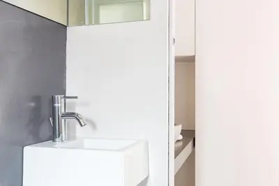 a bathroom with a white sink and a mirror at Campo 13 Holiday Apartment in Rome